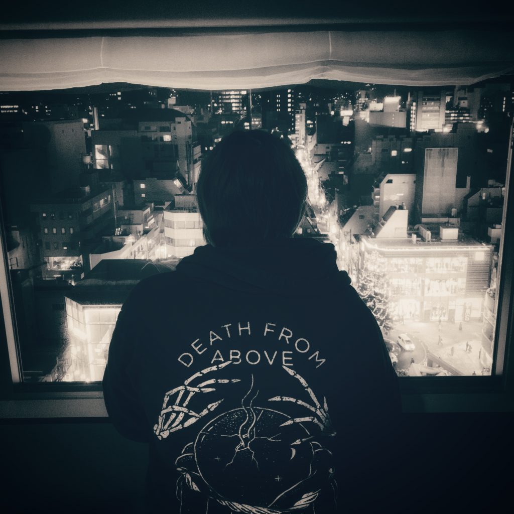 Shyla in front of our hotel window in her Death From Above hoodie