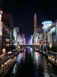 City of Osaka at night with reflection in the river running through it