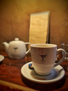 Coffee mug in front of menu