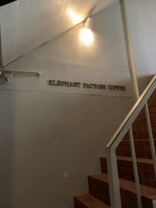 Elephant Factory Coffee black lettering on white wall