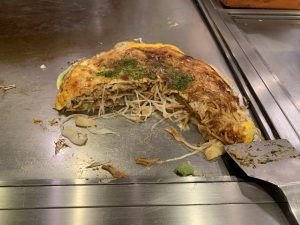 Okonomiyaki being eaten